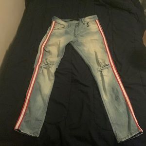 Skinny Blue Jeans with White and Red Strips on the sides.